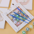Child painting on a small canvas using paint by numbers kit