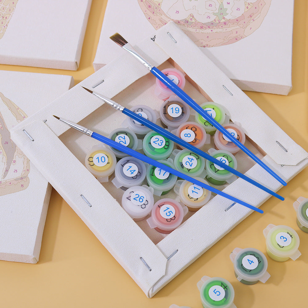 Child painting on a small canvas using paint by numbers kit