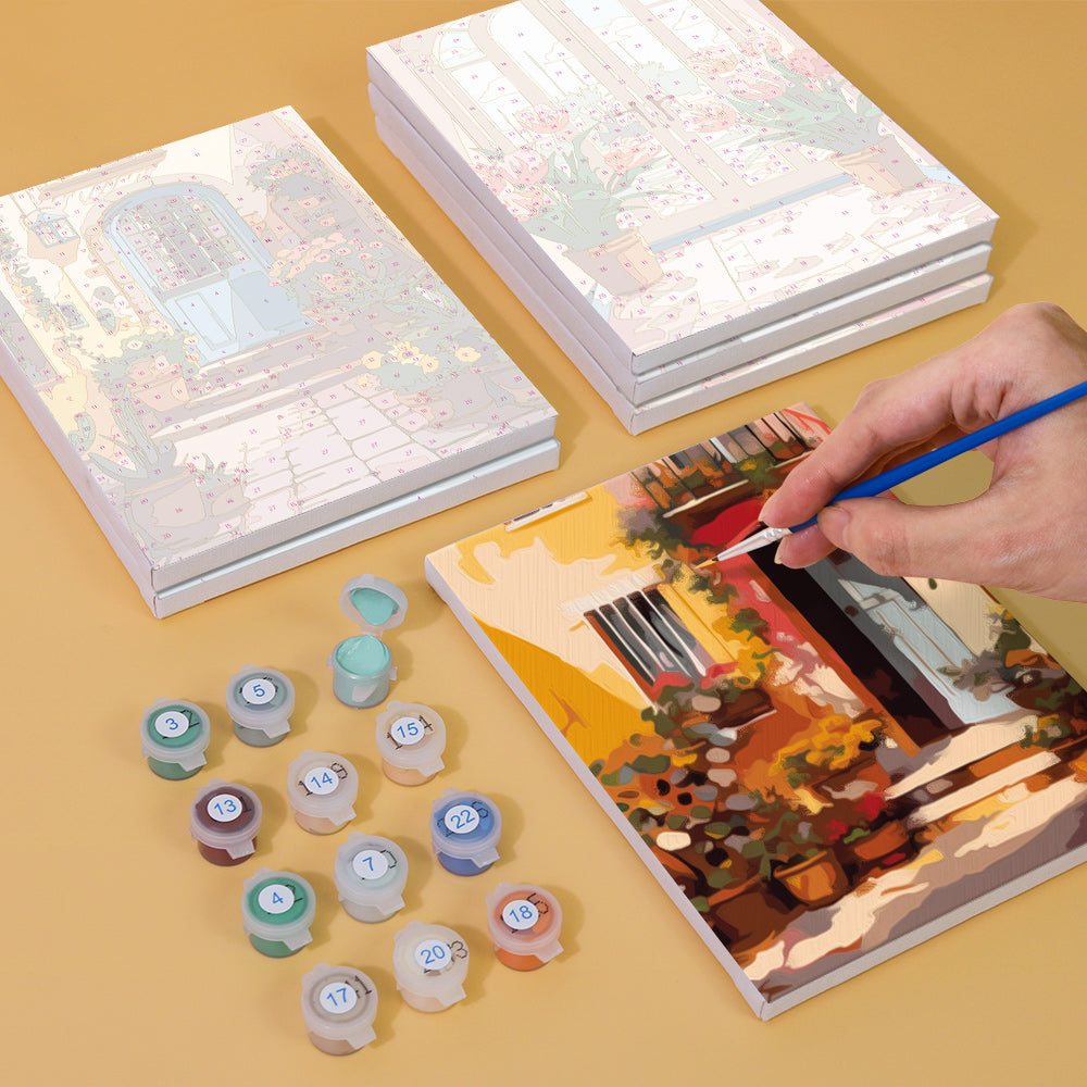 Small canvas paint by numbers set showing an arched entrance with blossoms