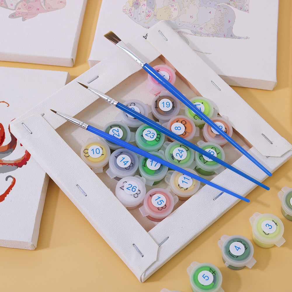 Close-up of paintbrush and numbered canvas with starfish design