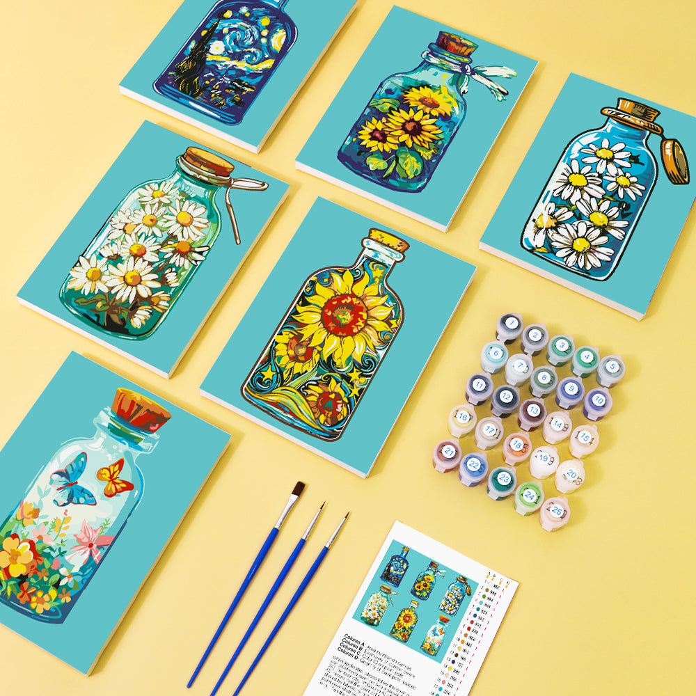 Hands holding a Bottled Wonders Mini Paint by Numbers Kit in progress