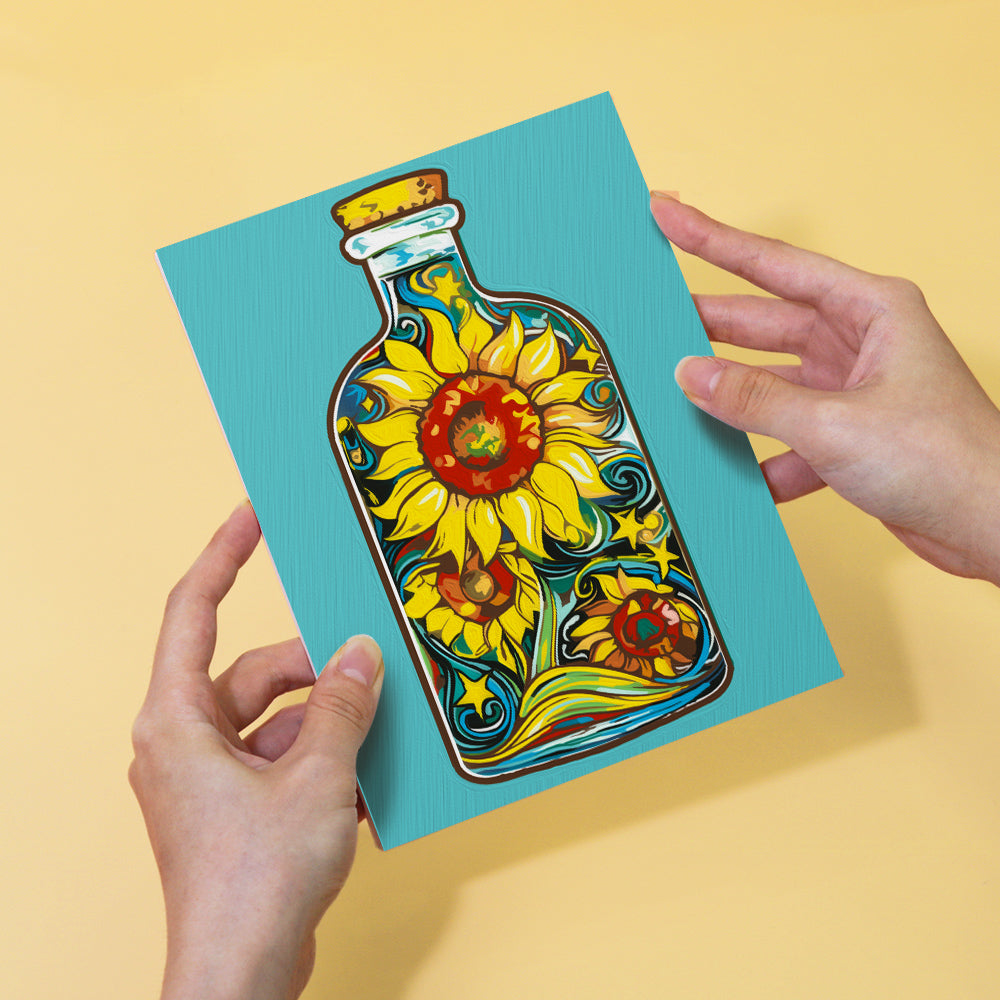 Miniature paintbrushes and paint pots with Bottled Wonders Kit on table