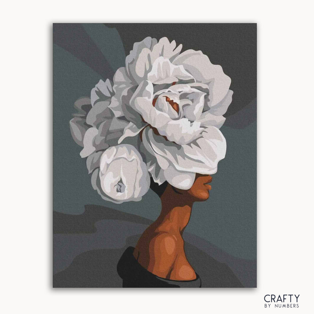 A paint-by-numbers kit image featuring the silhouette of a woman with a large arrangement of white roses.