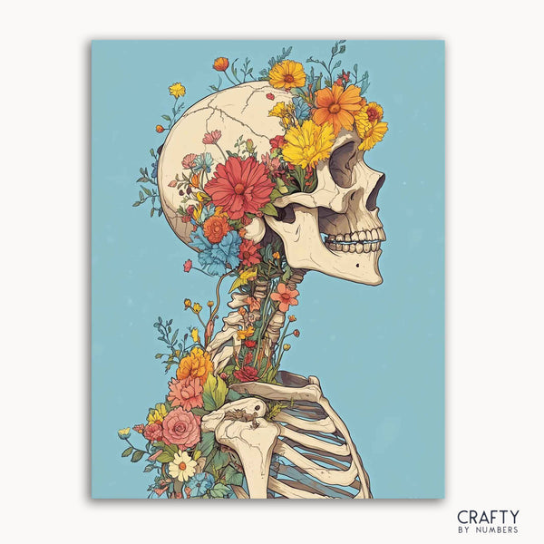 A paint by numbers kit depicting a skeleton with flowers growing from its head and neck, set against a blue background.