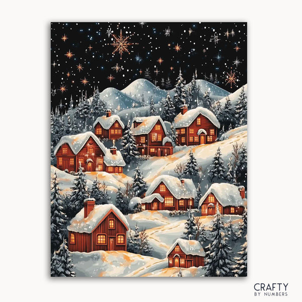 A paint by numbers kit depicting a winter village scene with snow-covered roofs and houses, a starry night sky, and frosted trees.collection