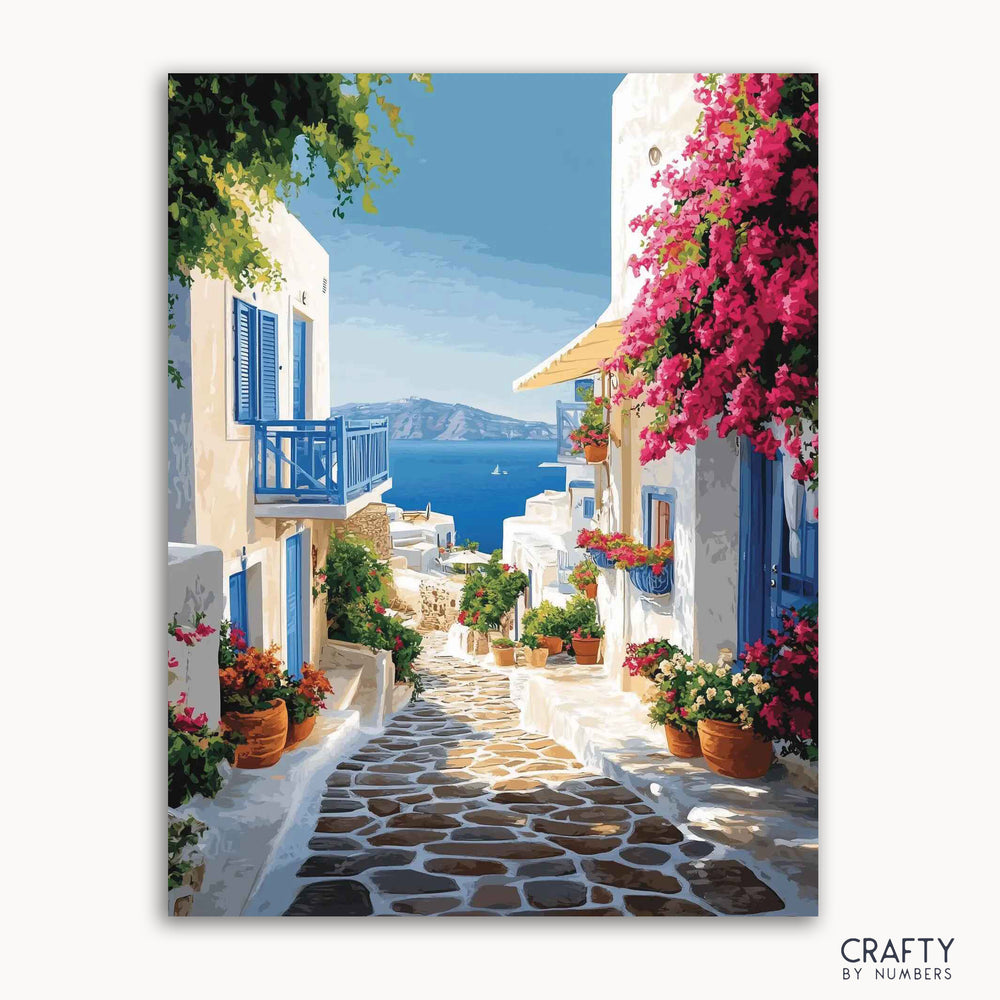 A paint-by-numbers kit depicting a sunlit village path with vibrant bougainvillea and houses, leading to a view of the Aegean Sea.