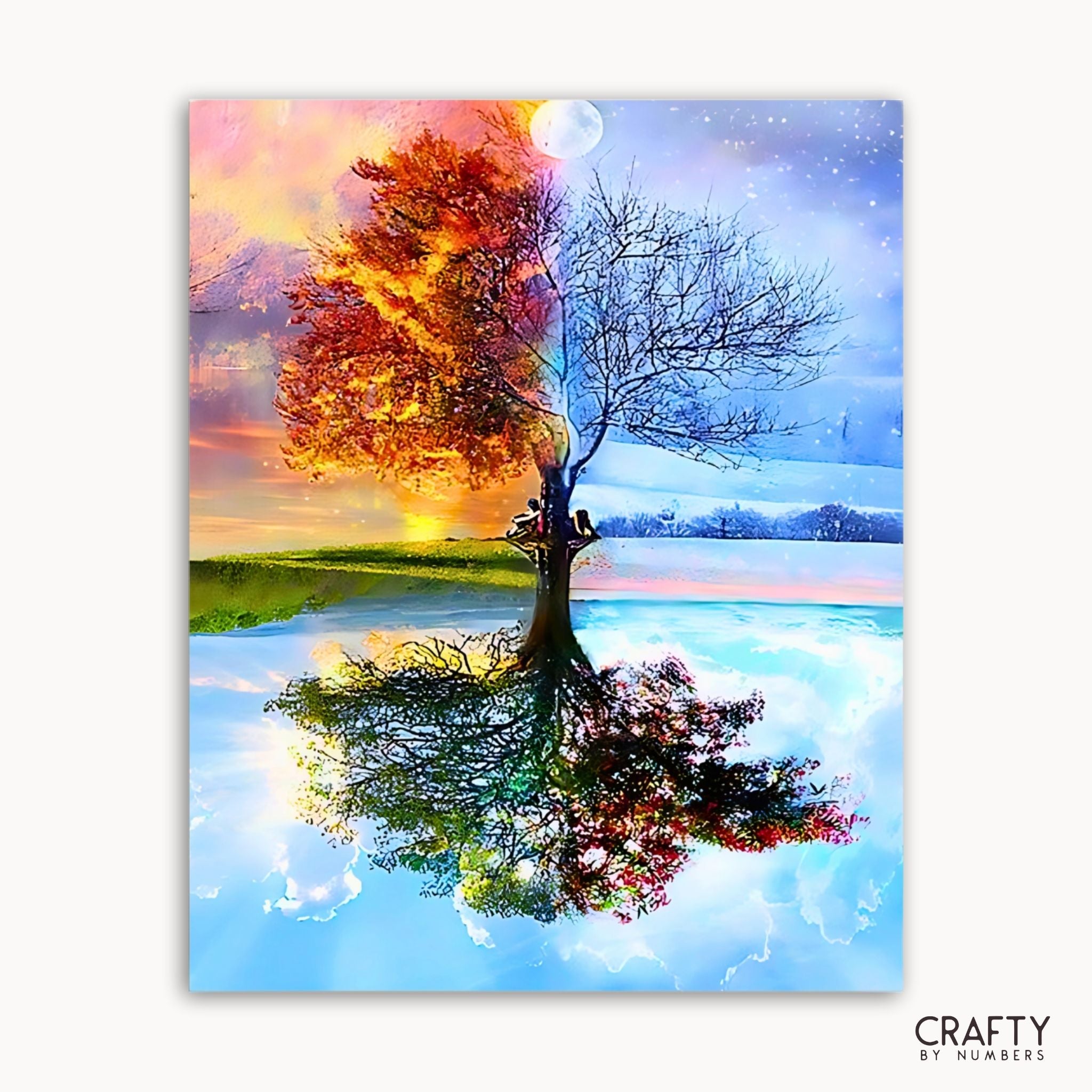 Colorful tree with autumn leaves reflected in water, surrounded by mountains and sky.