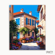 Painting of a picturesque street scene with flowers and buildings, featuring the brand 'Crafty by Numbers'.