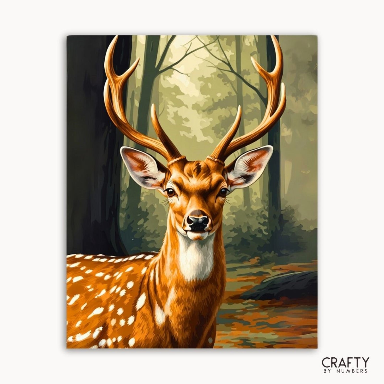Pintura de un ciervo con grandes astas en un entorno forestal, marca 'Crafty by Numbers' visible.