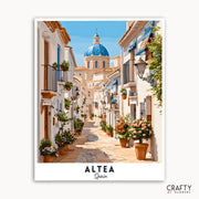Street scene in Altea, Spain with white buildings and a blue dome.