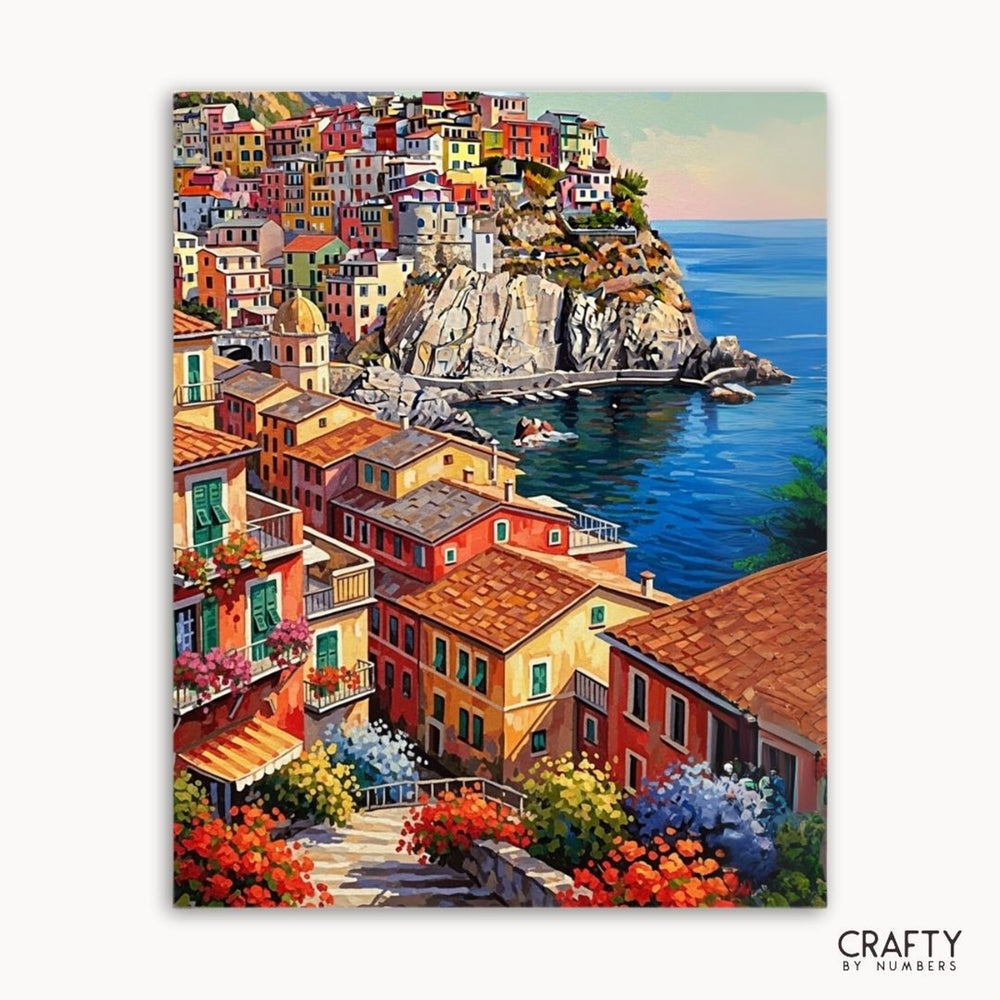 Colorful coastal town painting with houses and flowers, labeled 'Crafty by Numbers'.