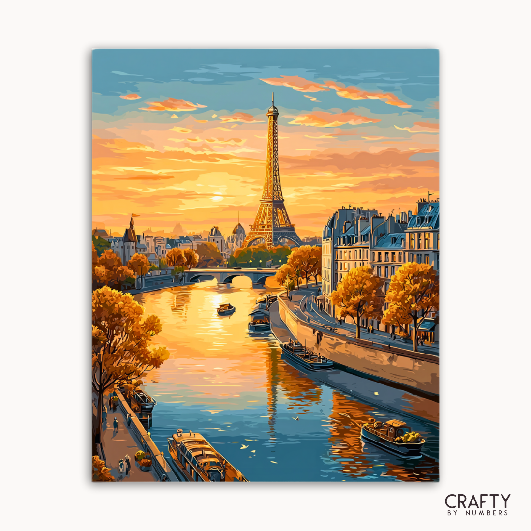 Pintura de la Torre Eiffel y el río Sena al atardecer, con la marca 'Crafty by Numbers'.