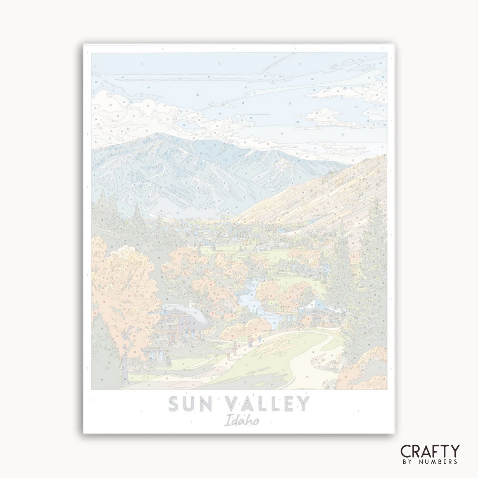 Impresión artística de un paisaje montañoso con el texto "Sun Valley, Idaho" y la marca "Crafty by Numbers".