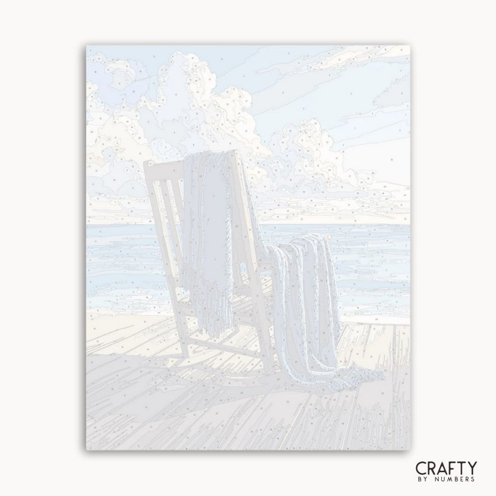 Beach scene with lounge chairs and sand, featuring the brand 'Crafty by Numbers'.