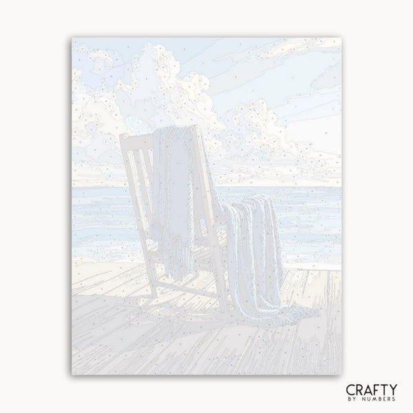 Beach scene with lounge chairs and sand, featuring the brand 'Crafty by Numbers'.