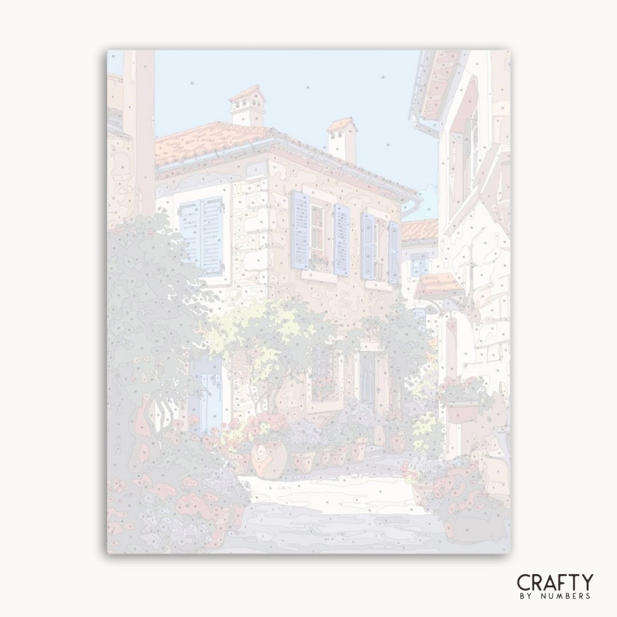 Framed artwork of a snowy village scene with houses and trees, featuring the brand 'Crafty by Numbers'.
