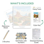 Set of art supplies including brushes, paint set, reference sheet, and detailed painting guide with a scenic print of Arizona.