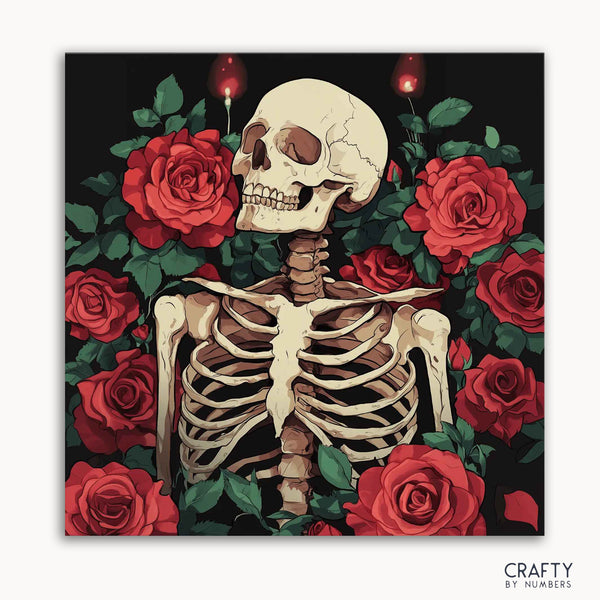A paint by numbers kit with a design of a skeleton surrounded by red roses.