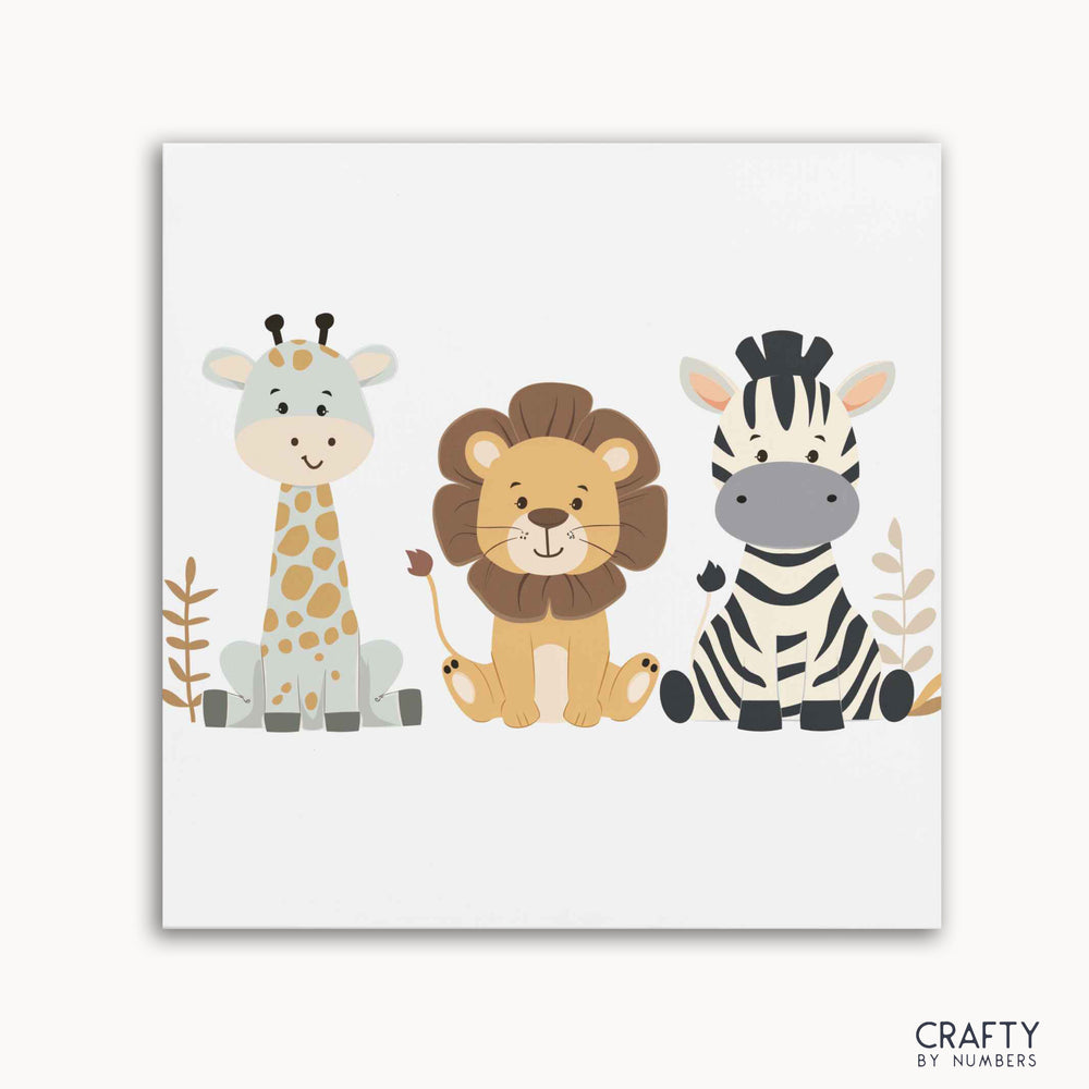A paint by numbers kit featuring illustrations of a giraffe, a lion, and a zebra on a white background, with the Crafty by Numbers logo at the bottom.