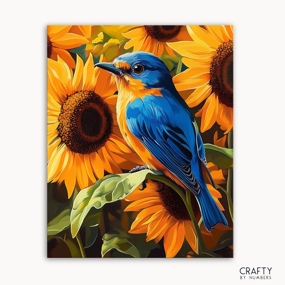 A paint by numbers kit image featuring a blue bird perched on sunflowers.