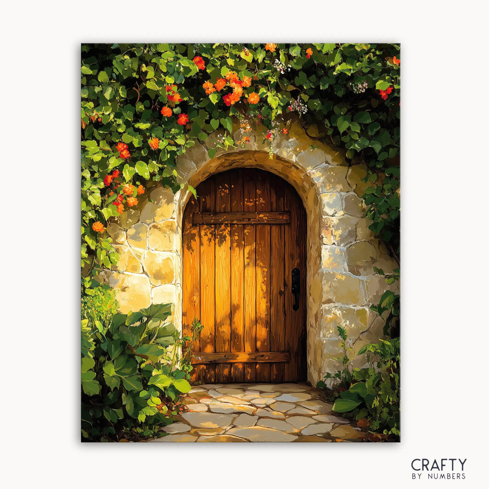 A canvas paint by numbers kit depicting a rustic garden gate with a wooden door surrounded by flowers and greenery, titled 'Sunset Garden Gate'.