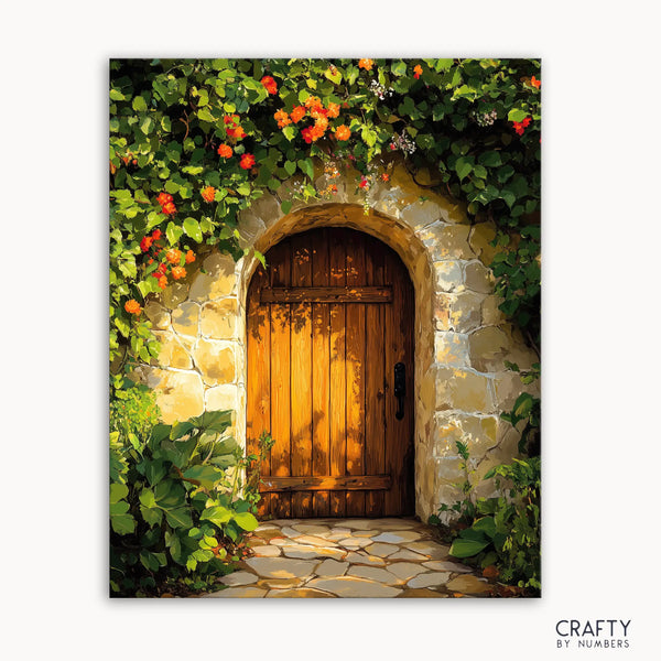 A canvas paint by numbers kit depicting a rustic garden gate with a wooden door surrounded by flowers and greenery, titled 'Sunset Garden Gate'.