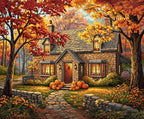 Stone house with autumn decorations and pumpkins in a scenic setting