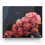 A paint-by-numbers kit depicting a cluster of lush, velvety roses in varying shades of deep crimson and soft pinks with a dark background.