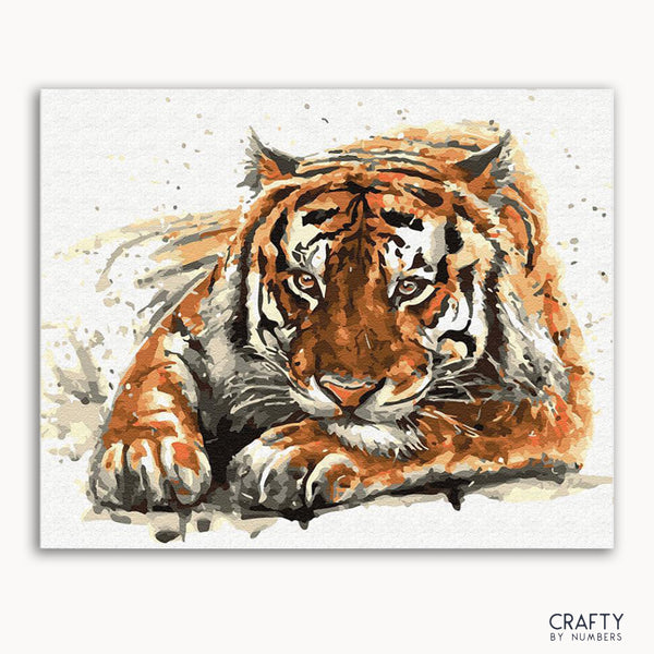 A watercolor painting of a lying Amur tiger with a focus on its face, against a white background.