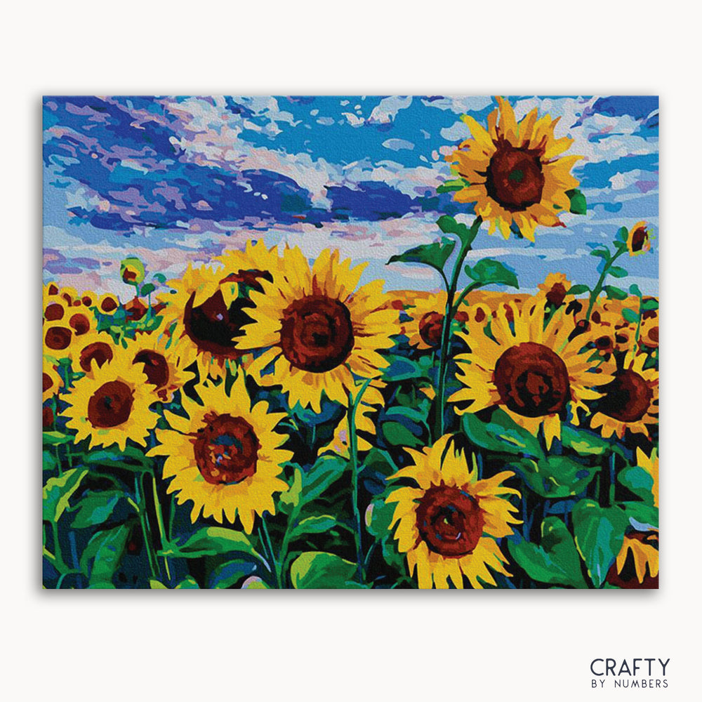 A painting of a field of sunflowers with a vibrant blue sky in the background, part of the 'Crafty by Numbers' collection.