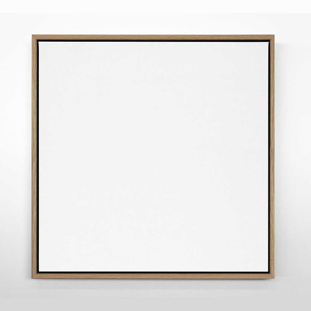 A framed canvas artwork with an oak wood frame, featuring a plain white surface.