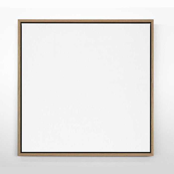 A framed canvas artwork with an oak wood frame, featuring a plain white surface.