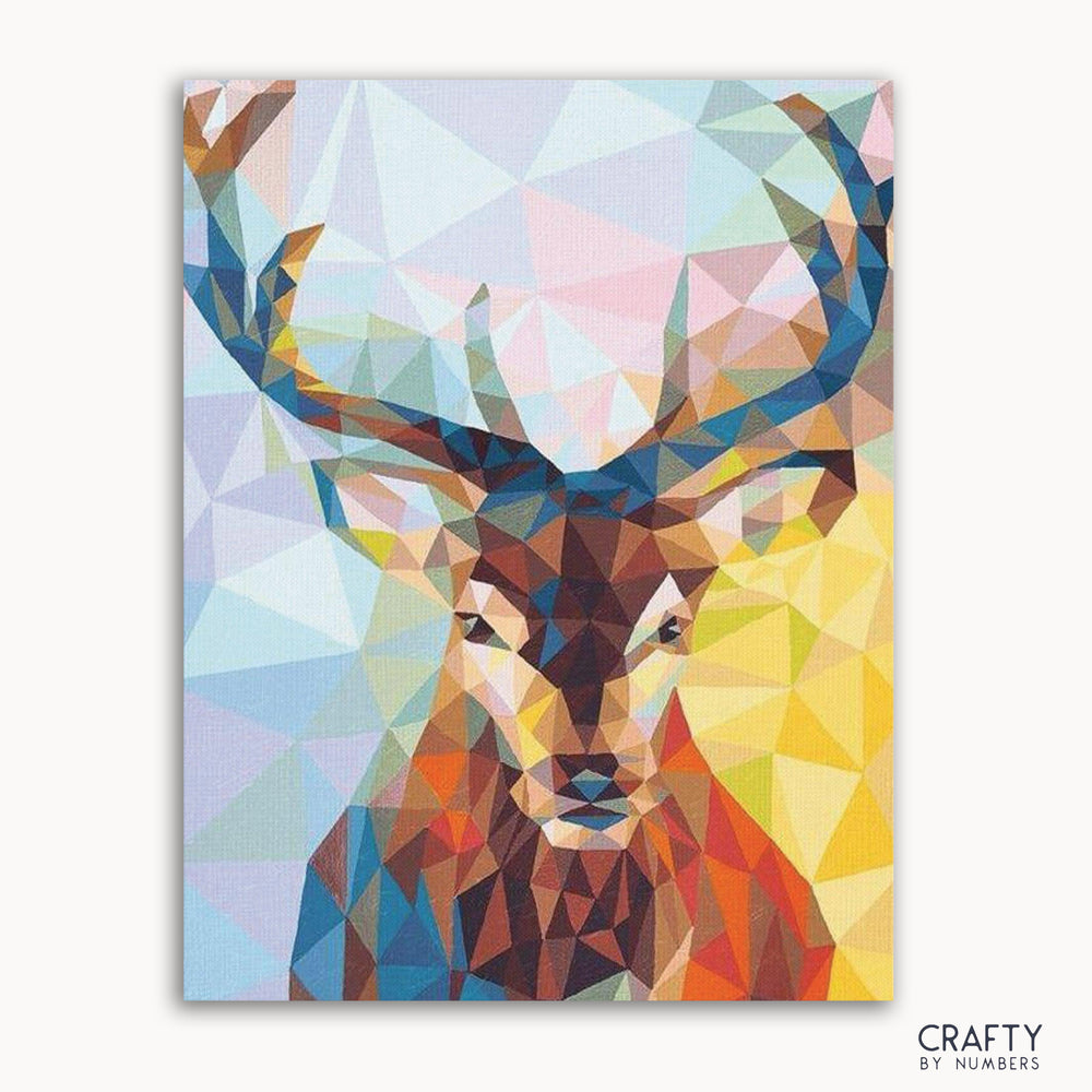 A paint-by-numbers kit depicting an abstract style deer with a geometric pattern in multiple colors on a framed canvas.