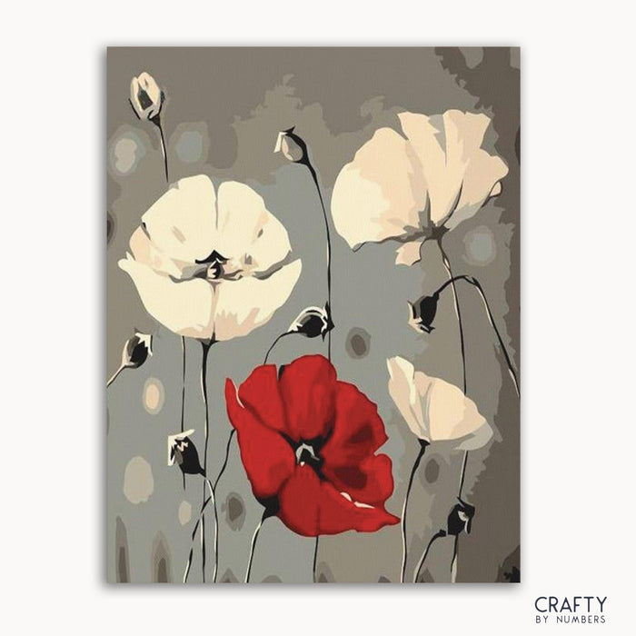 A paint-by-numbers kit image featuring abstract flowers, with primarily red and white colors on a gray background, labeled 'CRAFTY by Numbers'.