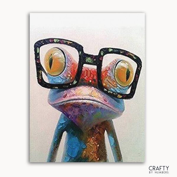 A colorful abstract painting of a frog with glasses, with a 'Crafty by Numbers' logo in the bottom right corner.