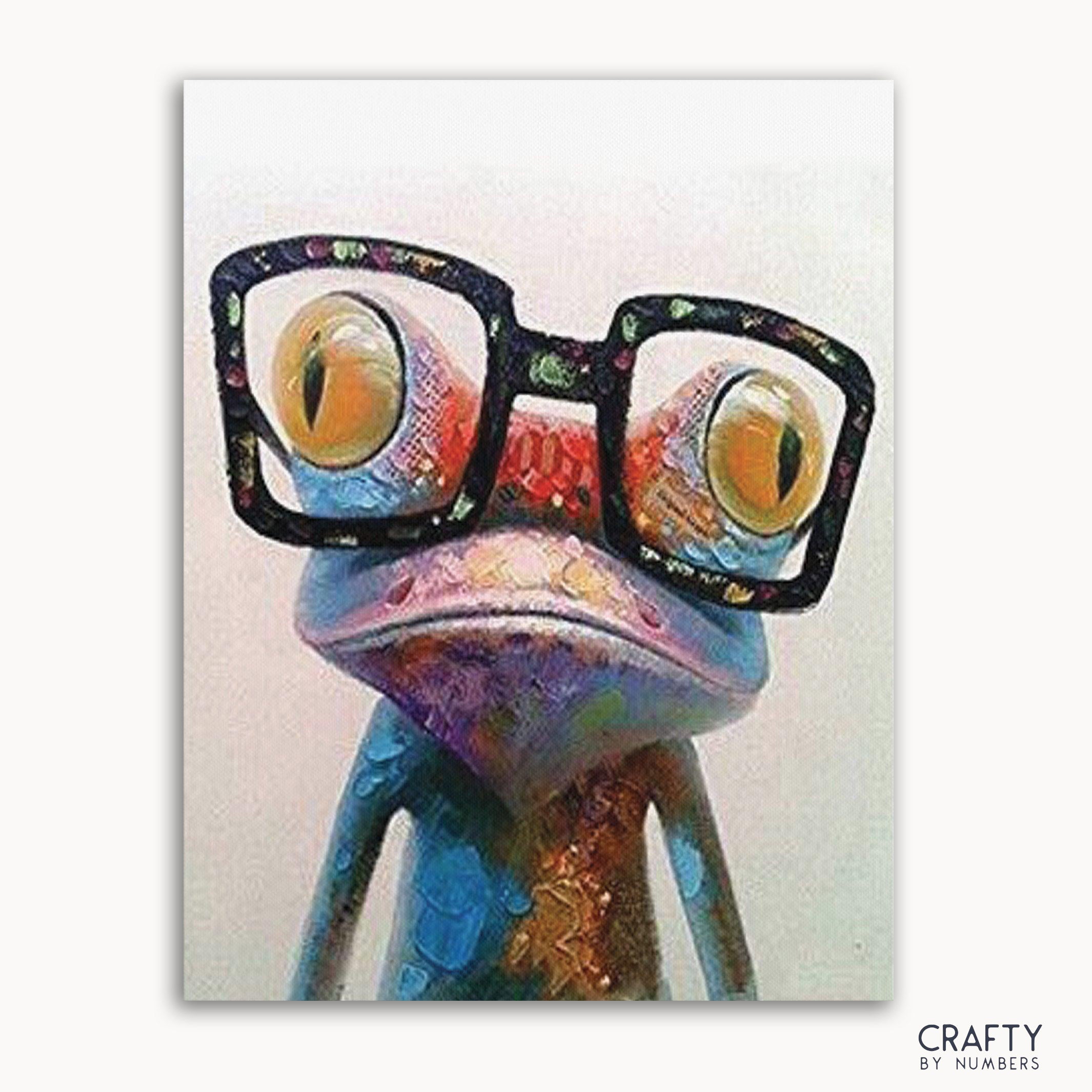 A colorful abstract painting of a frog with glasses, with a 'Crafty by Numbers' logo in the bottom right corner.