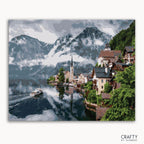 A paint-by-numbers kit depicting a town in the Austrian Alps with mountains in the background, mostly in shades of blue, green, and white.