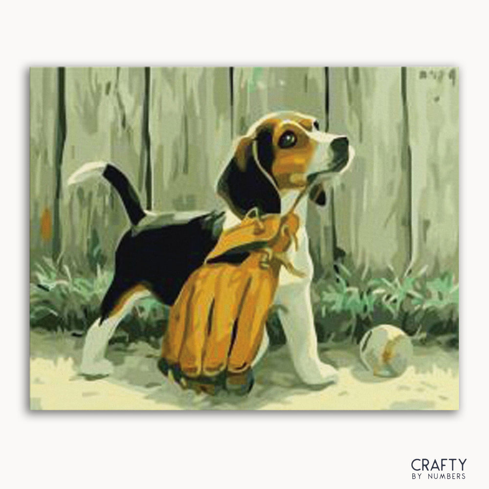 A paint-by-numbers kit depicting a puppy with a baseball glove in front of a wooden fence.