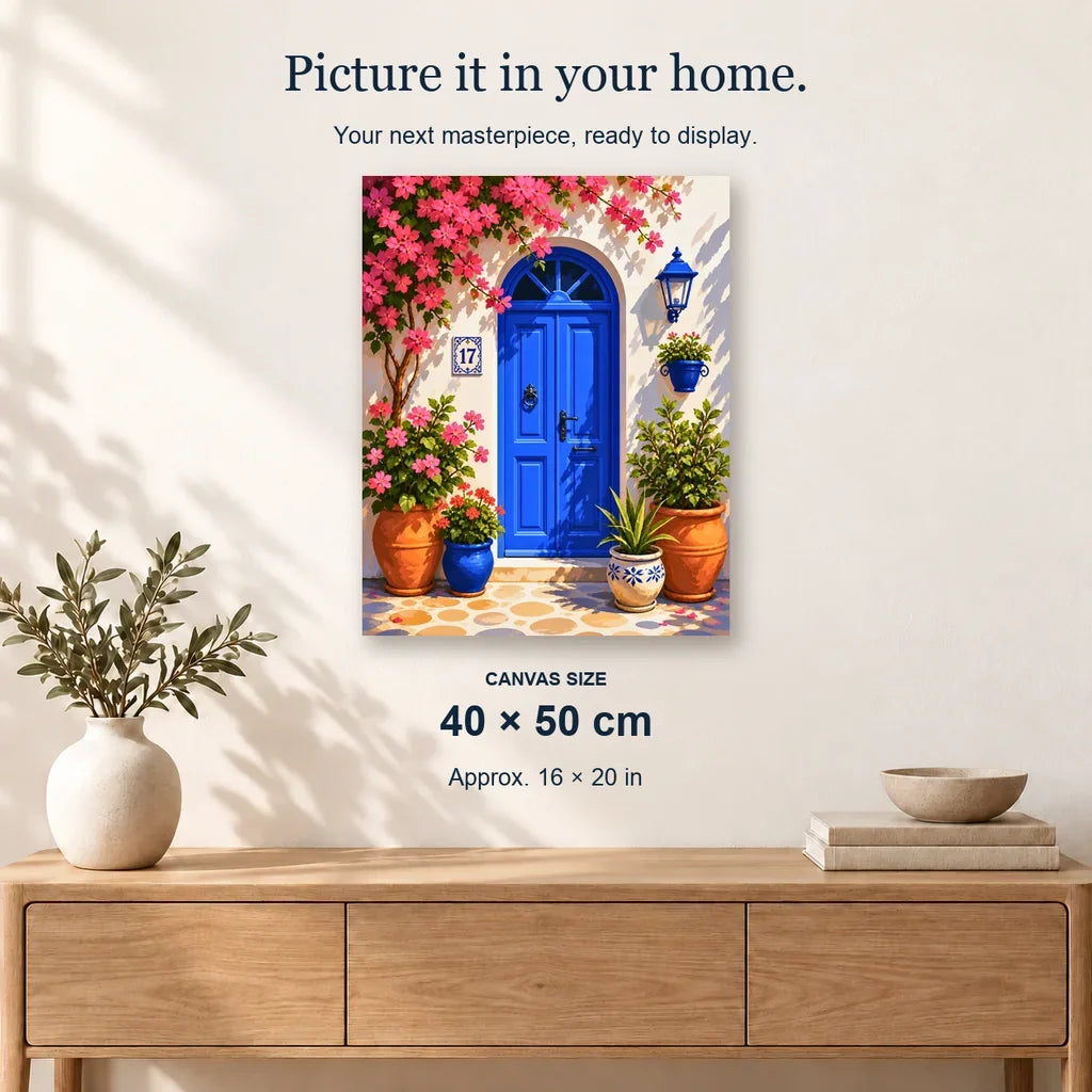 Blue Mediterranean Door displayed on a sunlit wall above an oak cabinet. Canvas size 40 × 50 cm.