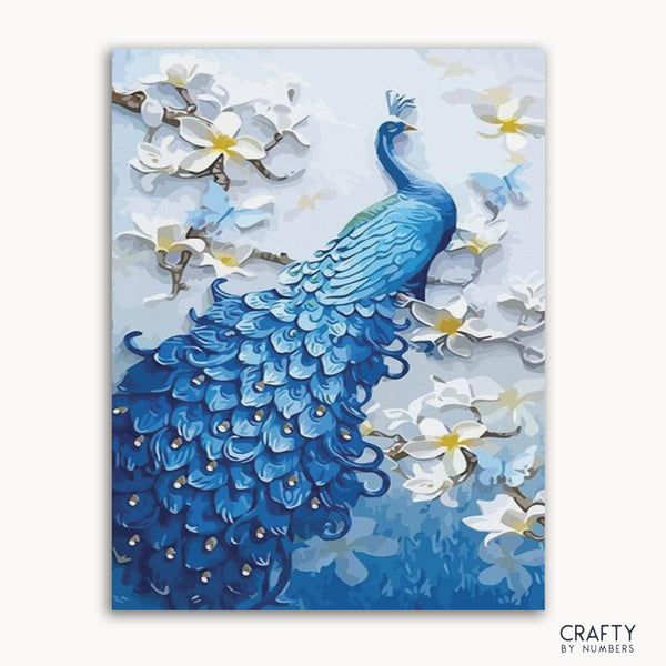 A paint-by-numbers kit depicting a blue peacock surrounded by white flowers on a framed canvas.