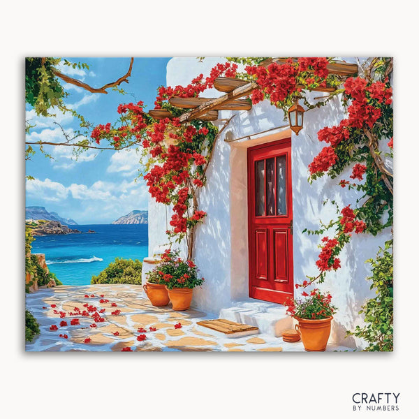 A paint-by-numbers kit depicting a vibrant scene with a red door, bougainvillea flowers, and a view of the sea in the background.