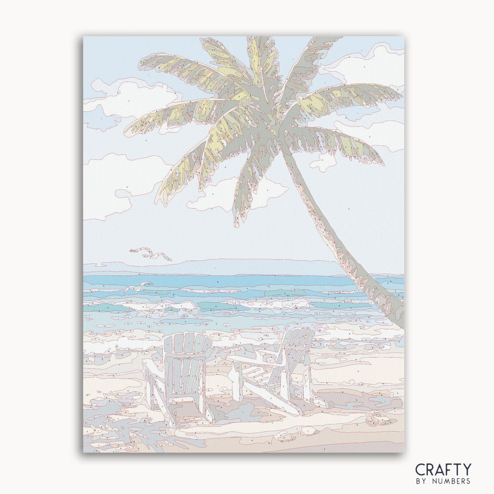 Paint-by-numbers kit featuring two wooden chairs on a sandy beach at sunset.