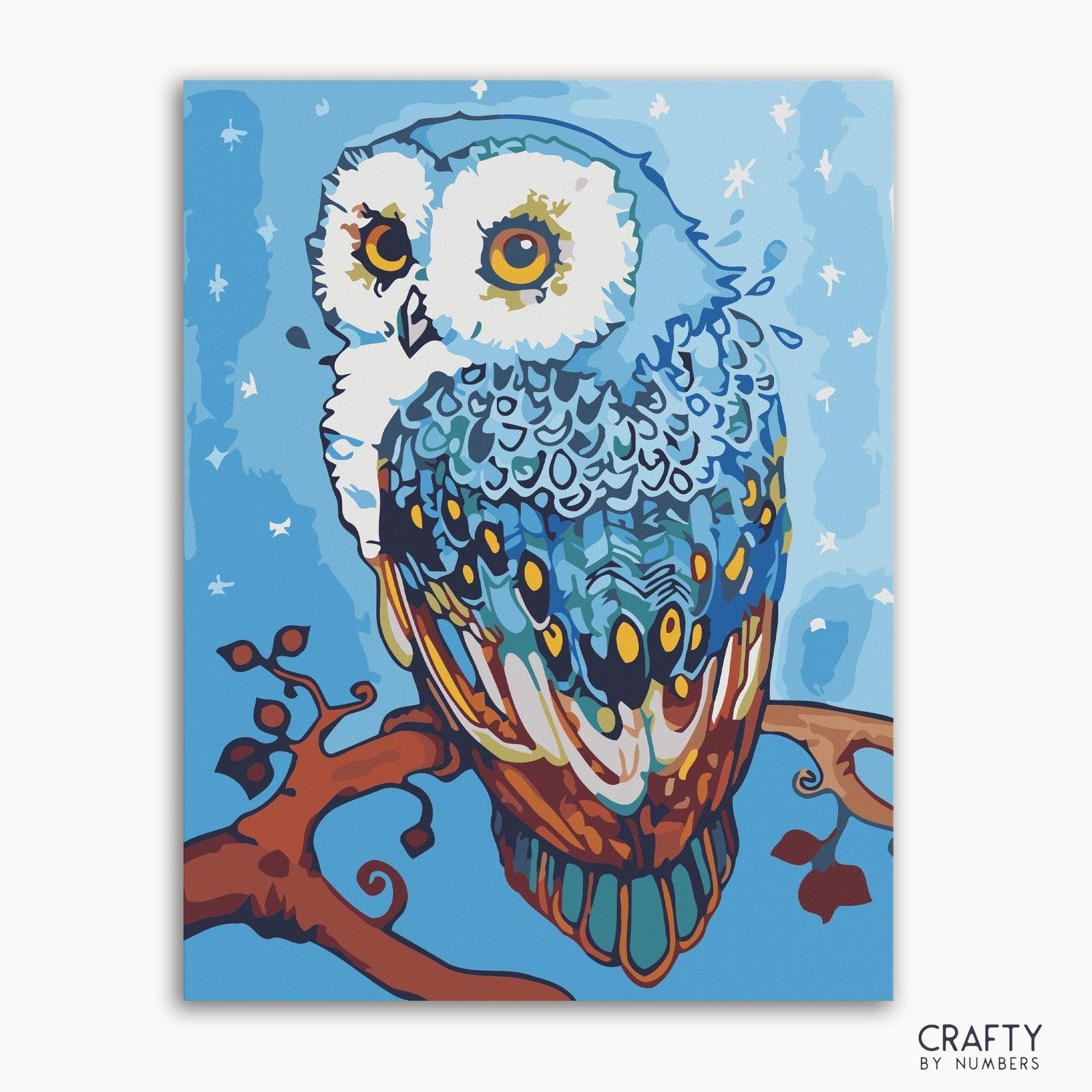 Imagen de un kit de pintura por números que presenta un colorido diseño de búho mandala sobre un lienzo enmarcado.