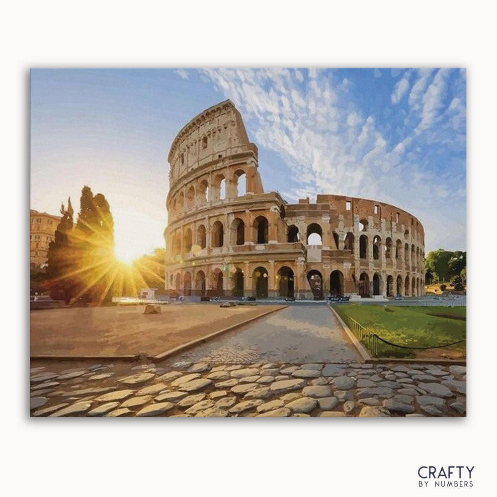 A paint-by-numbers kit depicting the Colosseum in Rome at sunset, with the sun's rays shining through the arches of the ancient structure.