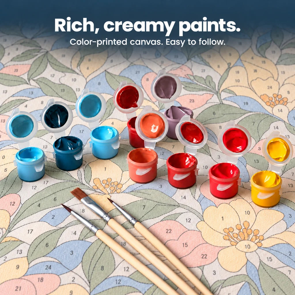 Open acrylic paint pots and three brushes on a canvas with lightly color-printed numbered sections.