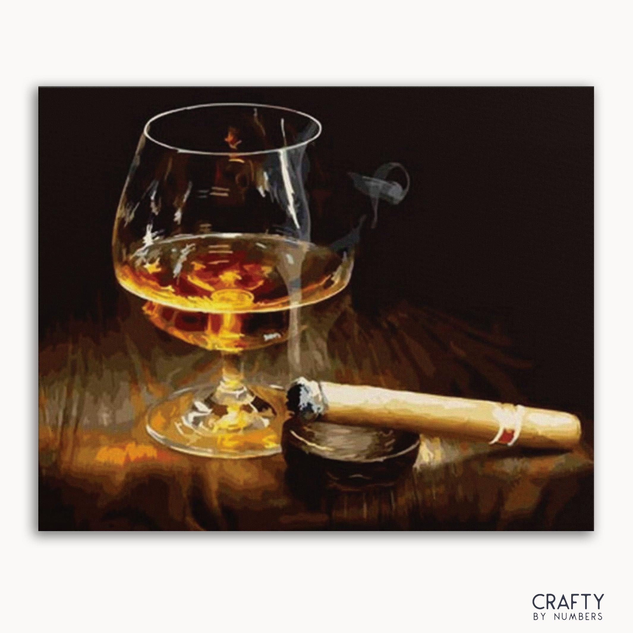 A paint by numbers kit depicting a glass of whiskey and a cigar on a wooden surface.