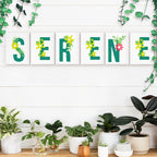 Decorative wall art spelling 'SERENE' with plants on a white wall.