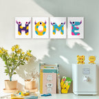 Four colorful wall art prints spelling 'HOME' above a desk with books and decorative items.