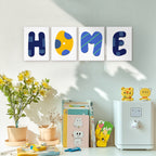 Decorative wall art spelling 'HOME' with colorful letters on a light gray wall.