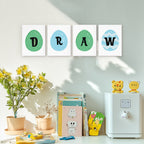 Decorative wall art with letters spelling 'DRAW' above a shelf with books and toys.